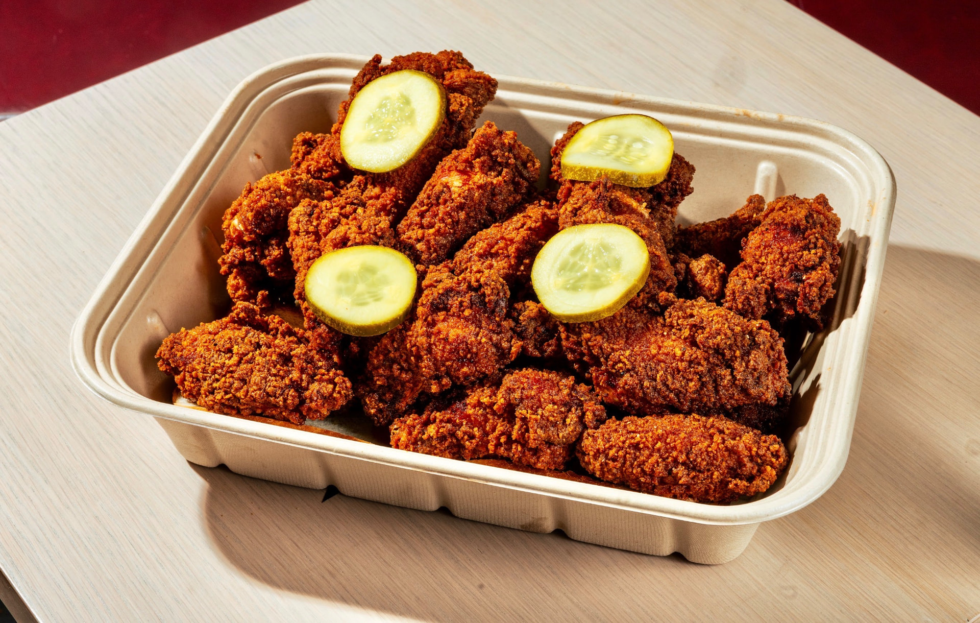 Takeout tray packed with hot chicken tenders