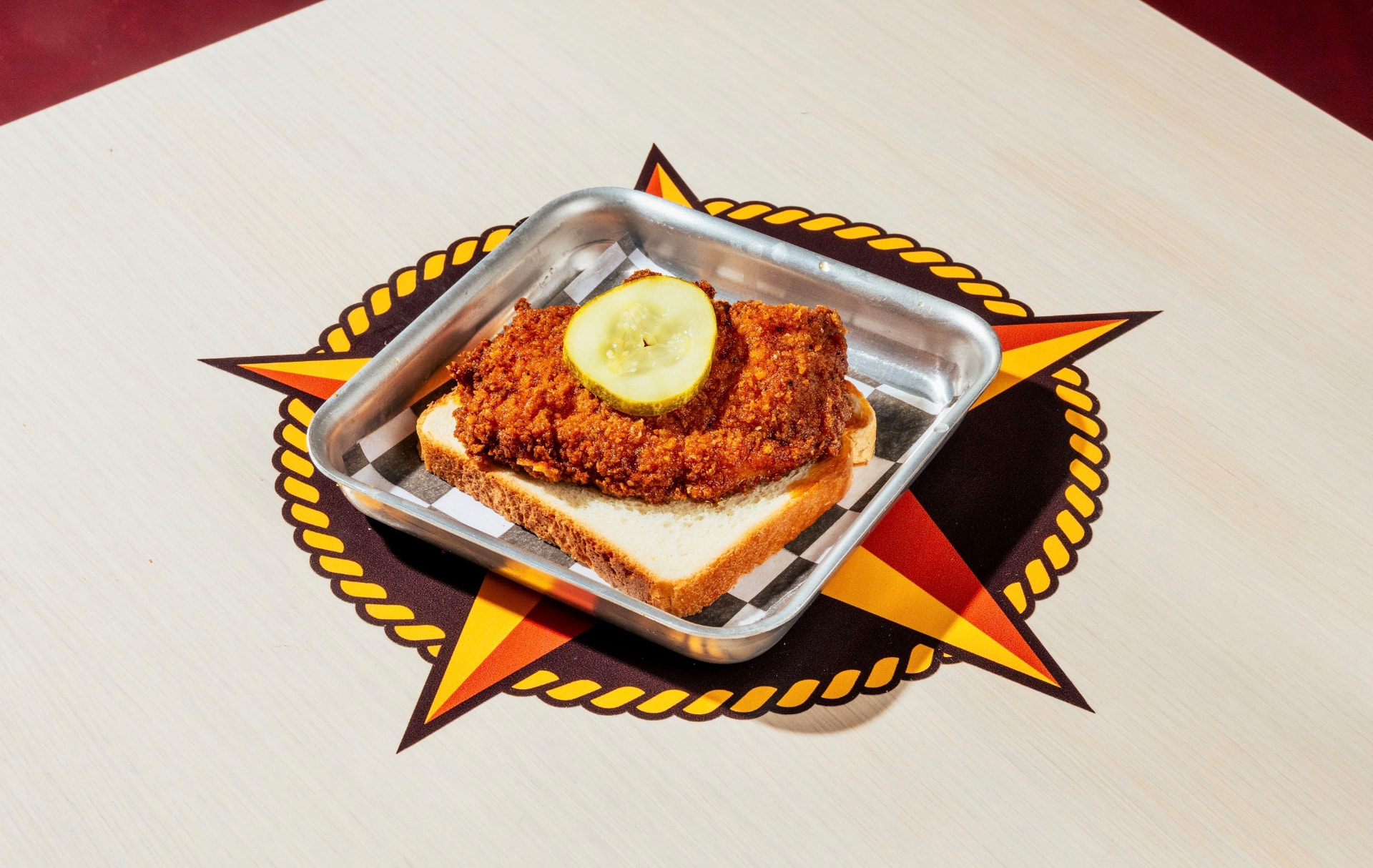 Hot chicken breast on white bread with a pickle