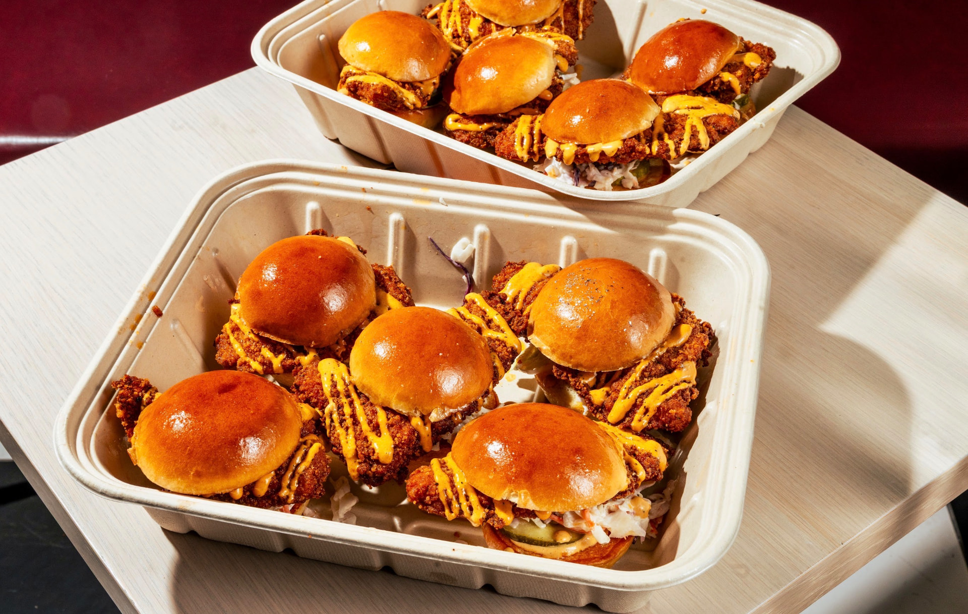 Two takeout trays of Hotbirds chicken sliders
