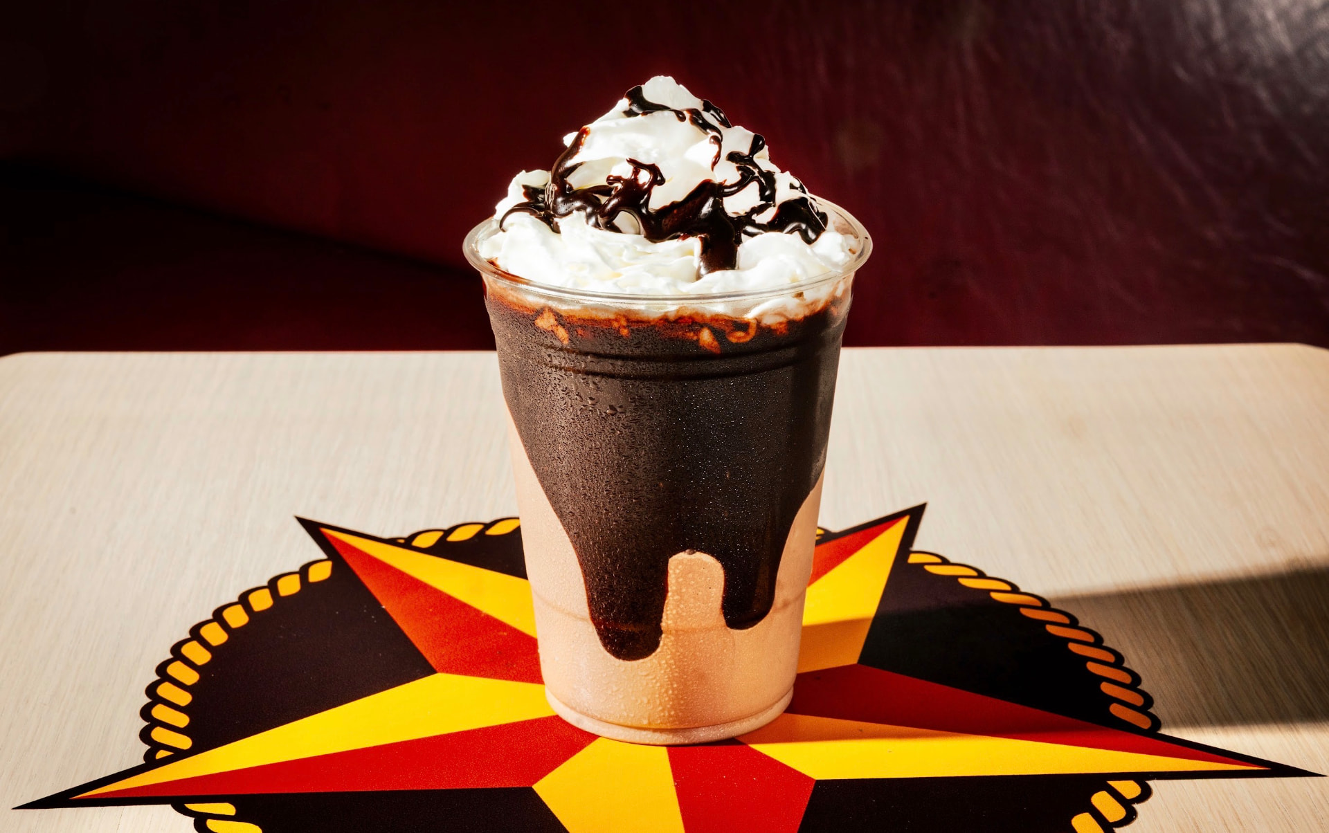 Chocolate milkshake with whipped cream and fudge drizzle